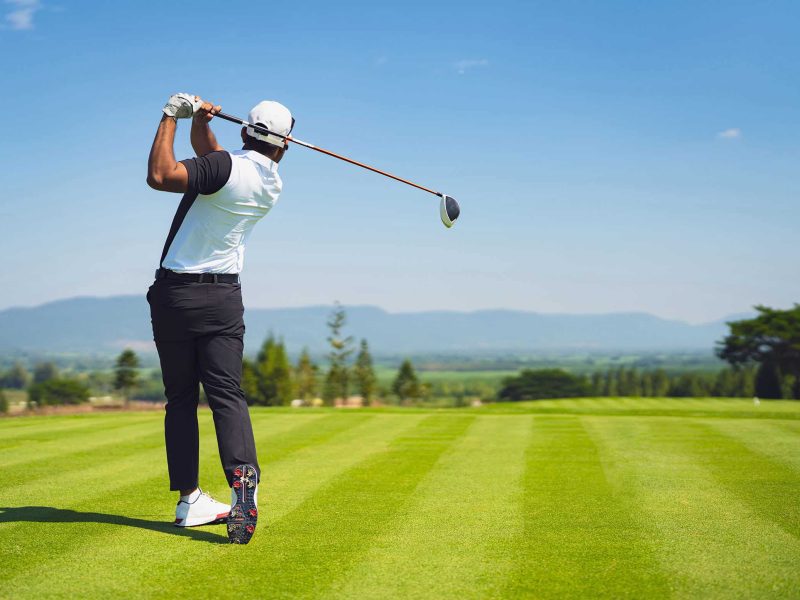 Asian Man Golfing On The Course. In Summer Asian Man Golfing On The Course. In Summer